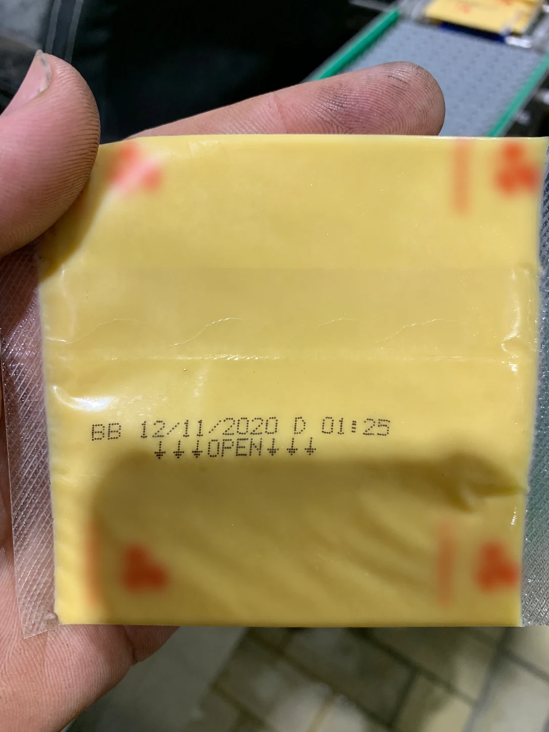 Two-line Hitachi UX-D inkjet code printed on flexible cheese-slice packaging