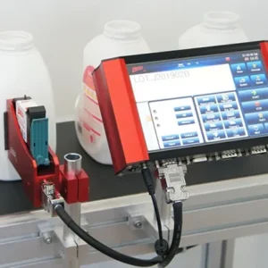 RED TIJ thermal inkjet printer controller and single printhead beside bottles on a conveyor