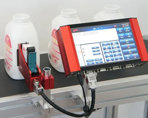 RED TIJ thermal inkjet printer controller and single printhead beside bottles on a conveyor